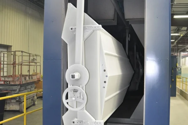 White bass-boat hull hanging on the conveyor at a convection oven entrance