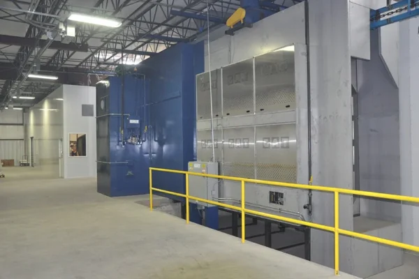 Hybrid infrared and convection oven line behind yellow guard railing