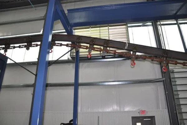 Overhead conveyor rail running the length of a plant bay