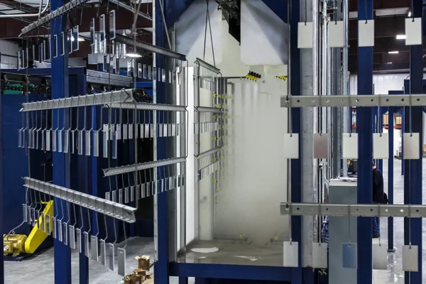 Racks of hooks on the conveyor at the washer entrance
